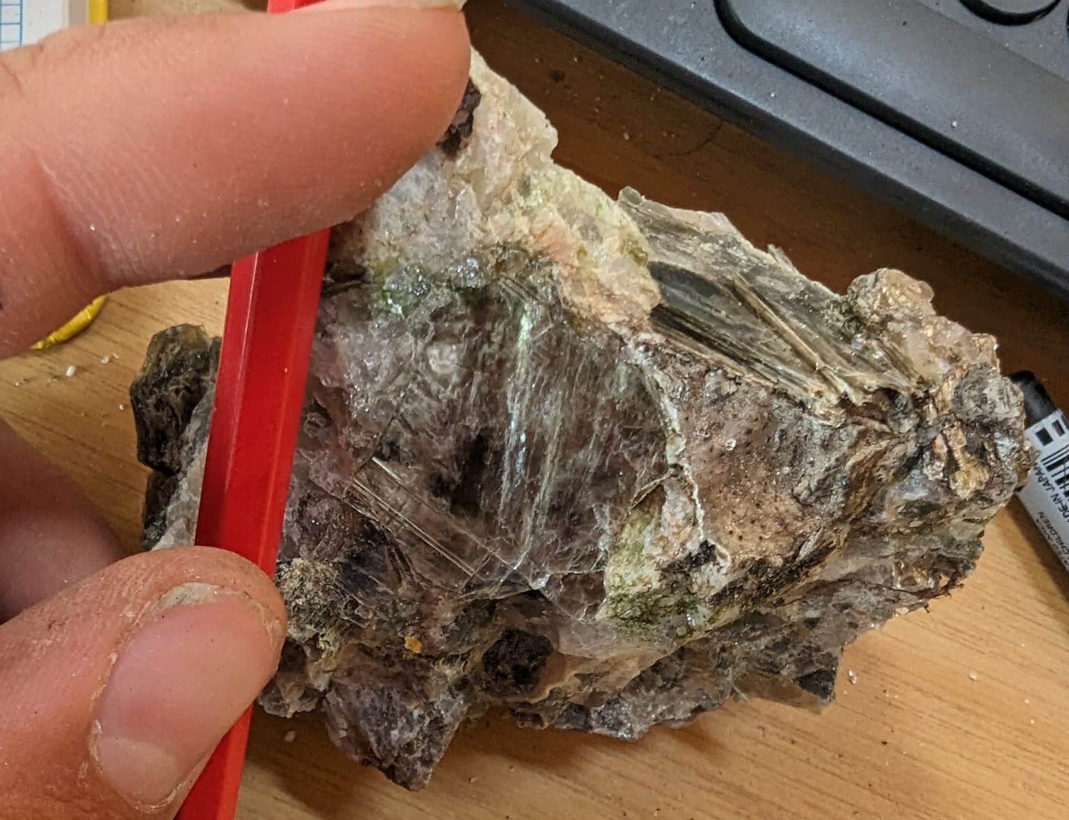 Photo of muscovite micas in a hand sample of pegmatite